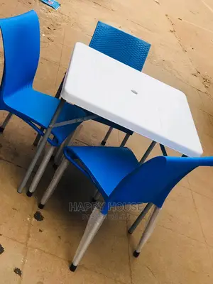 Set of Table and Four Plastic Chairs.