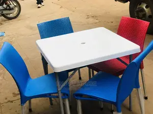 Set of Table and Four Plastic Chairs.