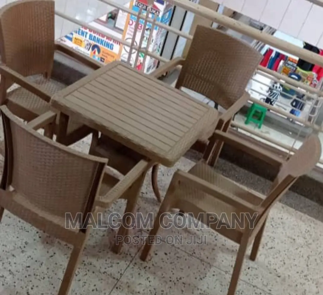 A Set of Four Strong Plastic Chairs and a Coffee Table