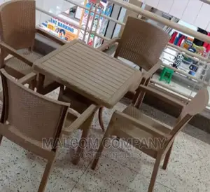 A Set of Four Strong Plastic Chairs and a Coffee Table