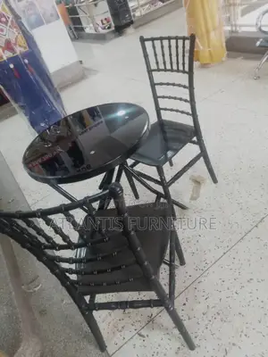 A Glass Table With Two Chairs