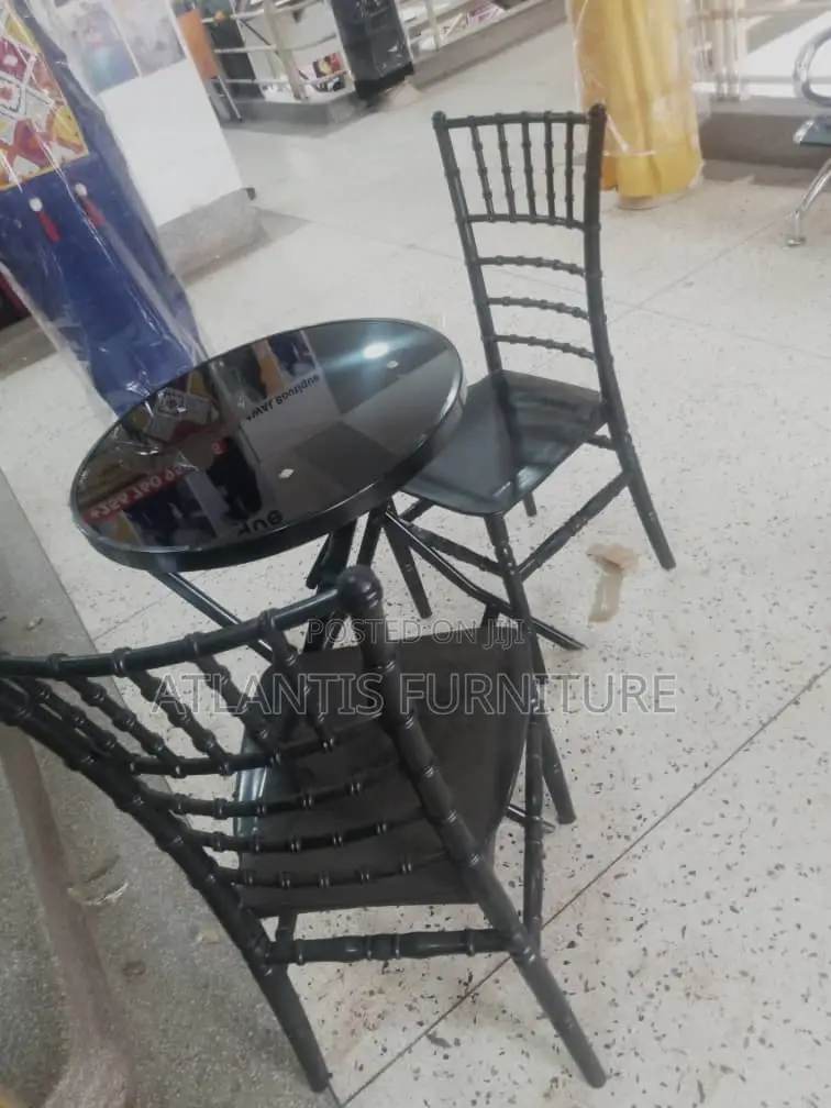 A Glass Table With Two Chairs