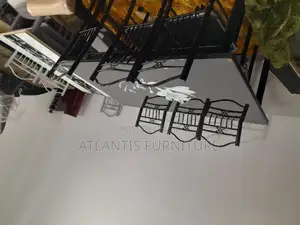 A Black Daining Table With Steel Legs.