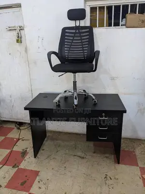 A Combo of an Office Table and a Mesh Headrest Chair