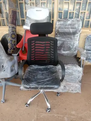 An Office Mesh Chair With Headrest