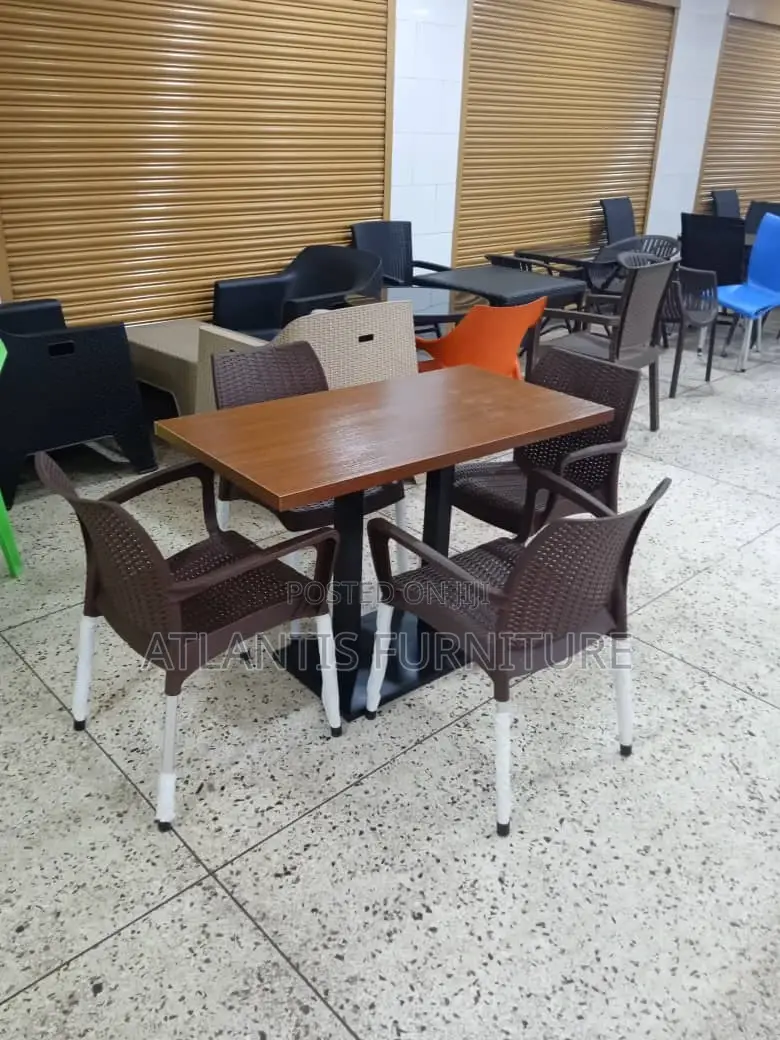 A Four Plastic Chair Plus Wooden Table Only.