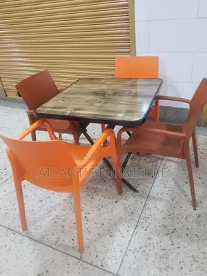 An Restaurant Dining Table With Four Chairs.