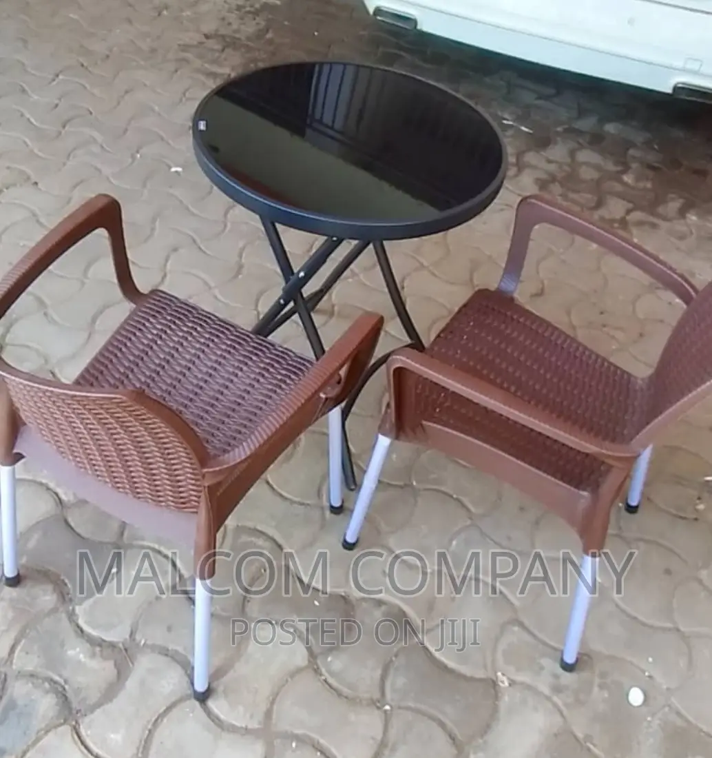 A Set Of Strong Plastic Chair With A Round Table