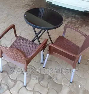 A Set Of Strong Plastic Chair With A Round Table