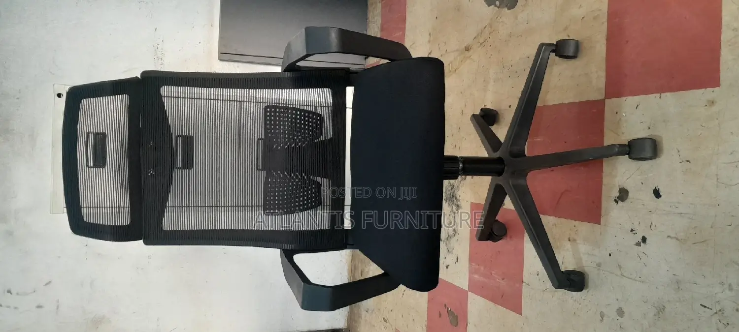 A Netted High Back Office Chair With Headrest .