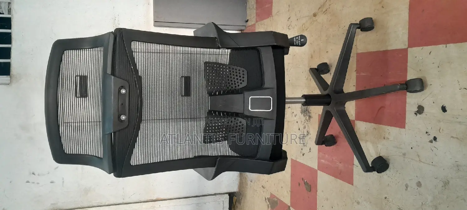 A Netted High Back Office Chair With Headrest .