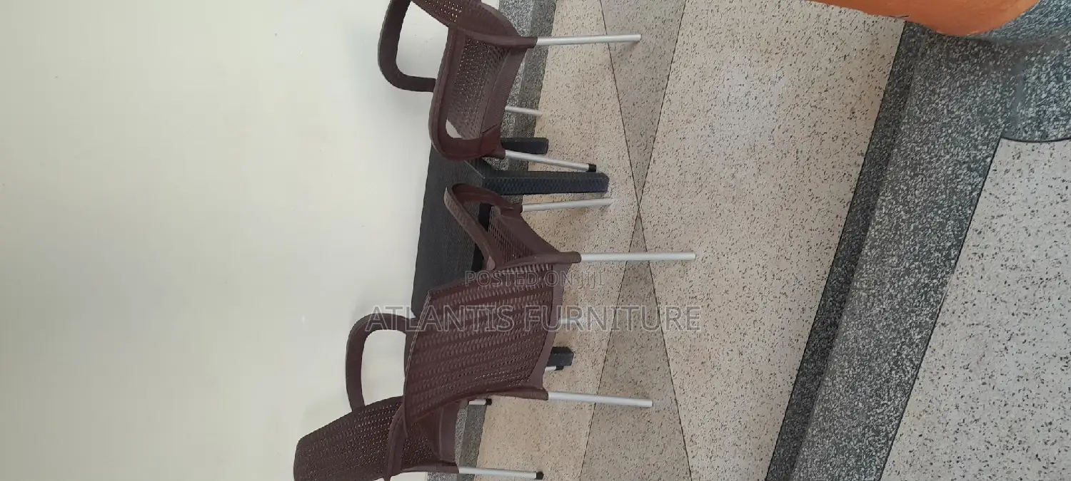 A Plastic Table (Very Nice)With Three Chairs.