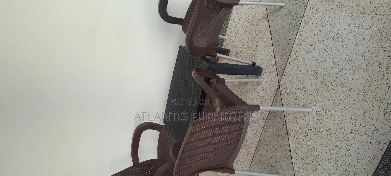 A Plastic Table (Very Nice)With Three Chairs.