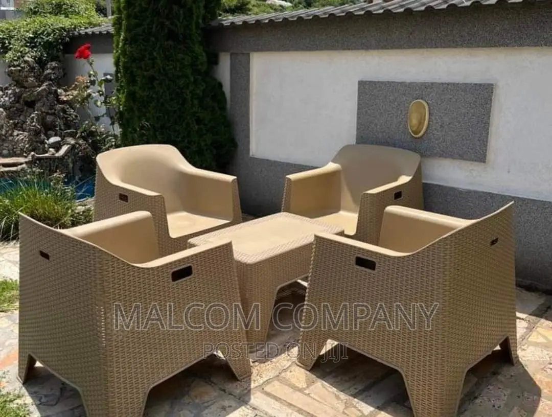 A Set of Four Plastic Chairs With a Table