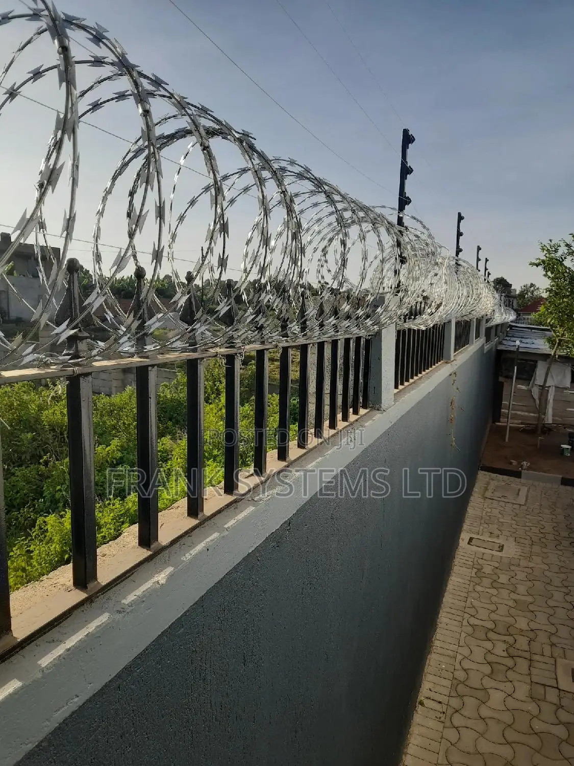 Electrified Fence System Backup With Razor Wire.
