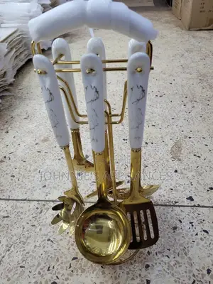 Gold And White Ceramic Serving Spoons On Are Set