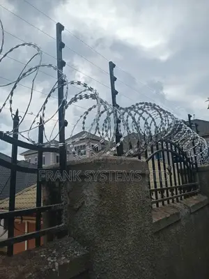 Electric Fence System With Razor Wire on Grills