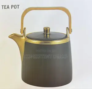 Gold Coated Tea Pot With a Wooden Handle