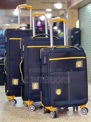 A Set of 3 Black Suitcases