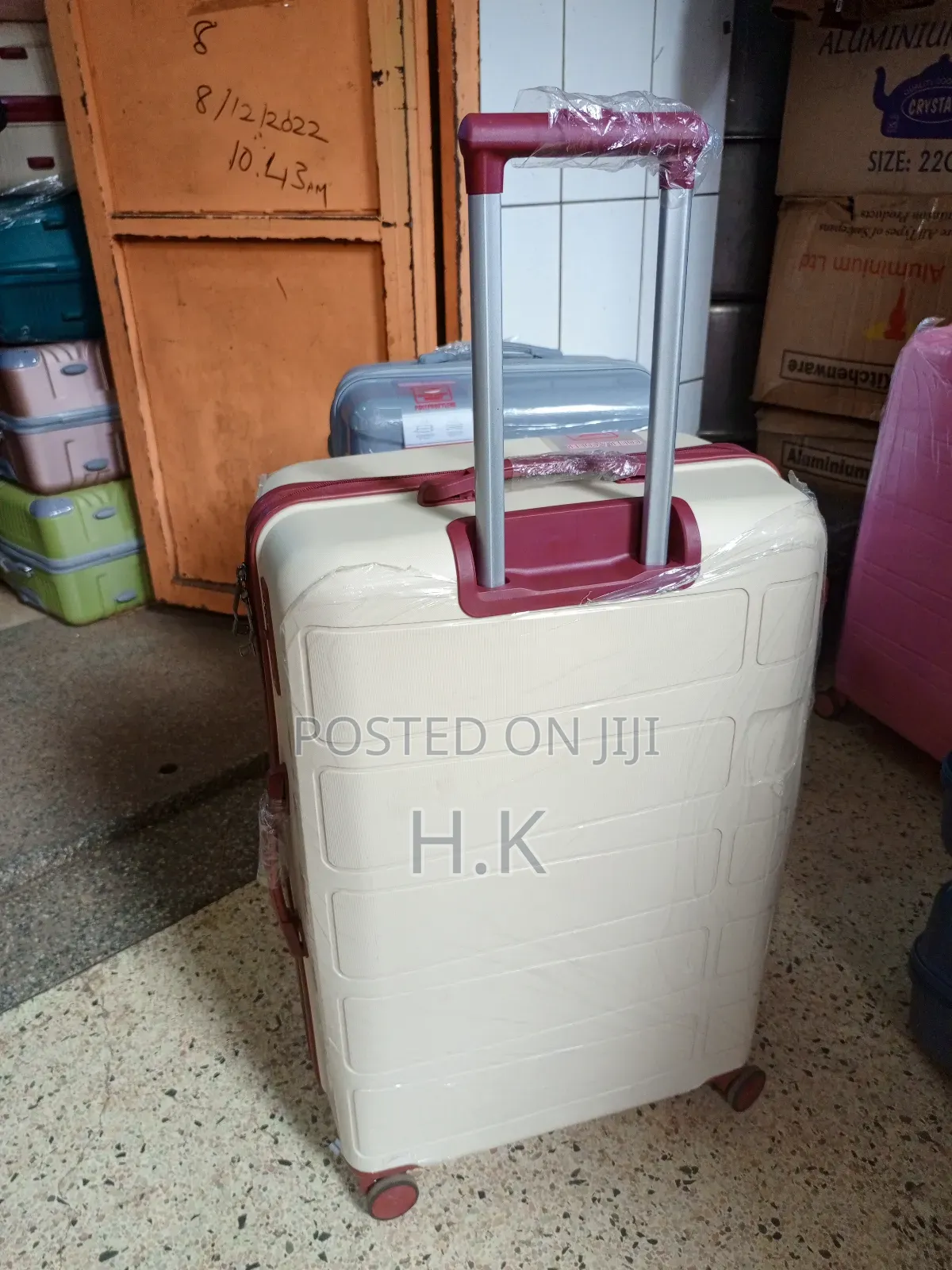 Beige Hard-Shell Suitcase With Spinner Wheels.