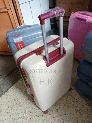 Beige Hard-Shell Suitcase With Spinner Wheels.