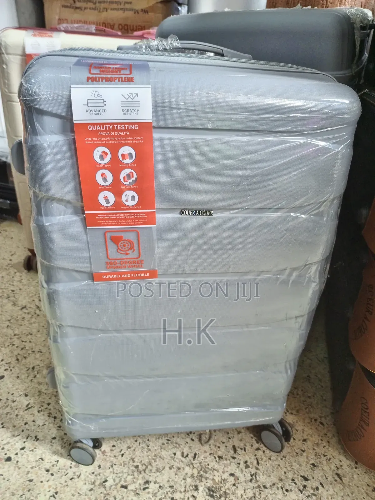 Beige Hard-Shell Suitcase With Spinner Wheels.
