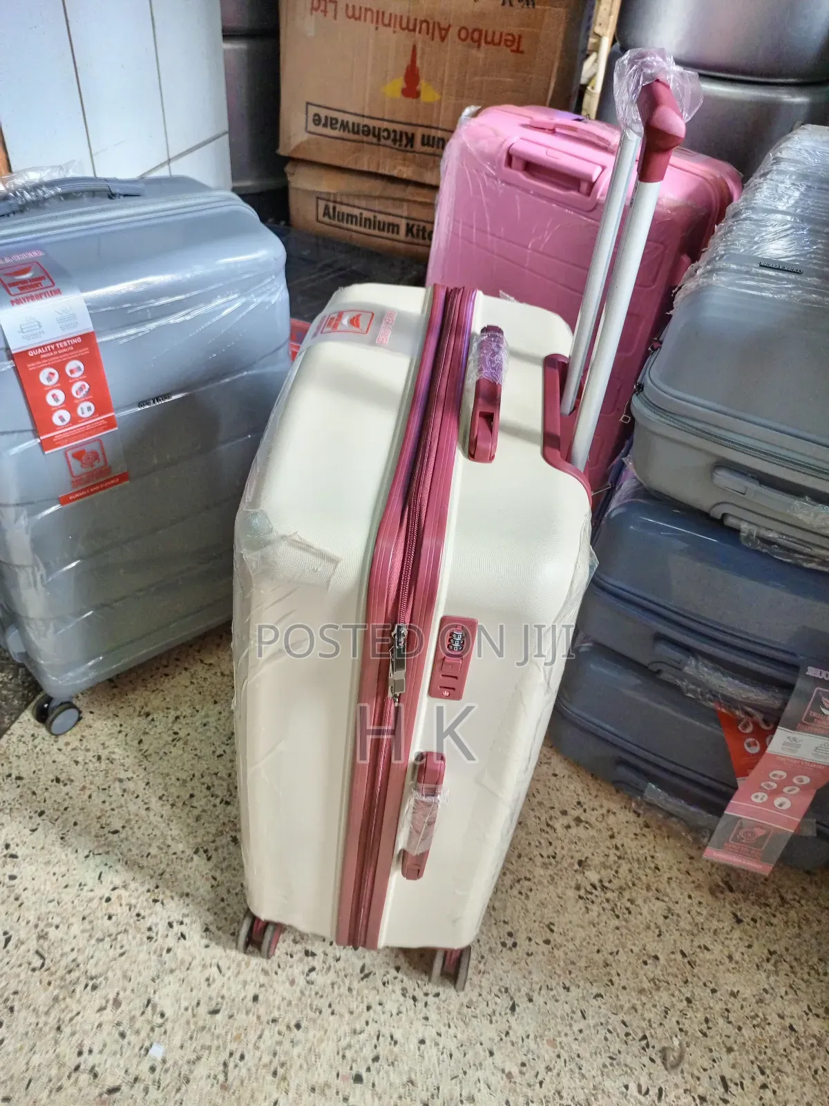 Beige Hard-Shell Suitcase With Spinner Wheels.
