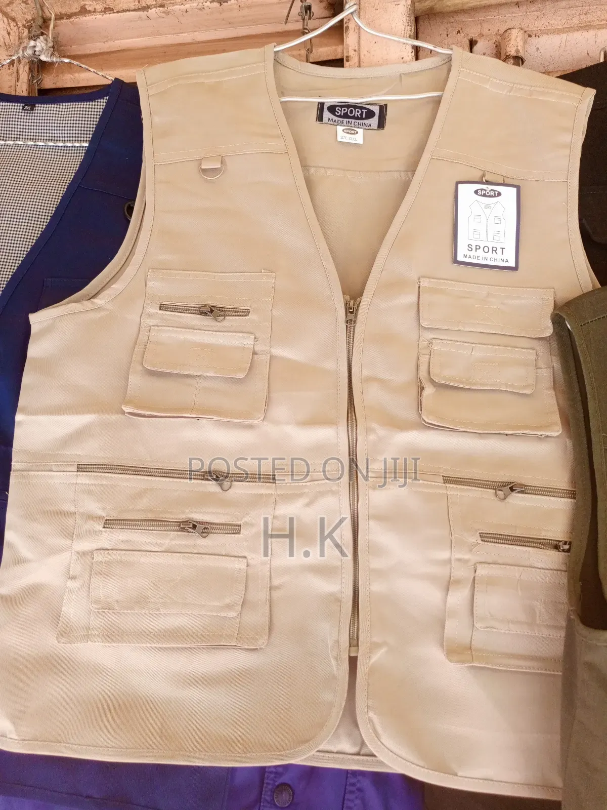 Beige Utility Vest With Multiple Pockets.