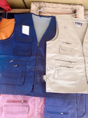 Beige Utility Vest With Multiple Pockets.