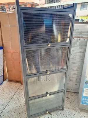 Grey Metal Storage Cabinet With Four Glass-Paned Doors.