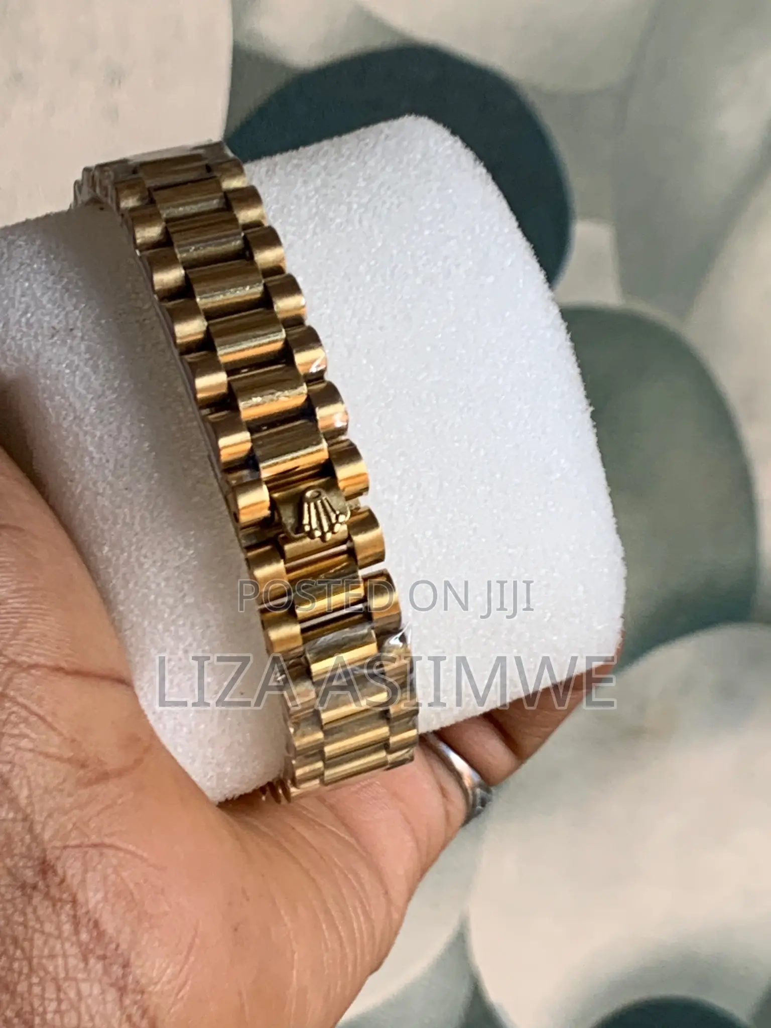 Lady’S Gold Rolex Watch With a White Dial