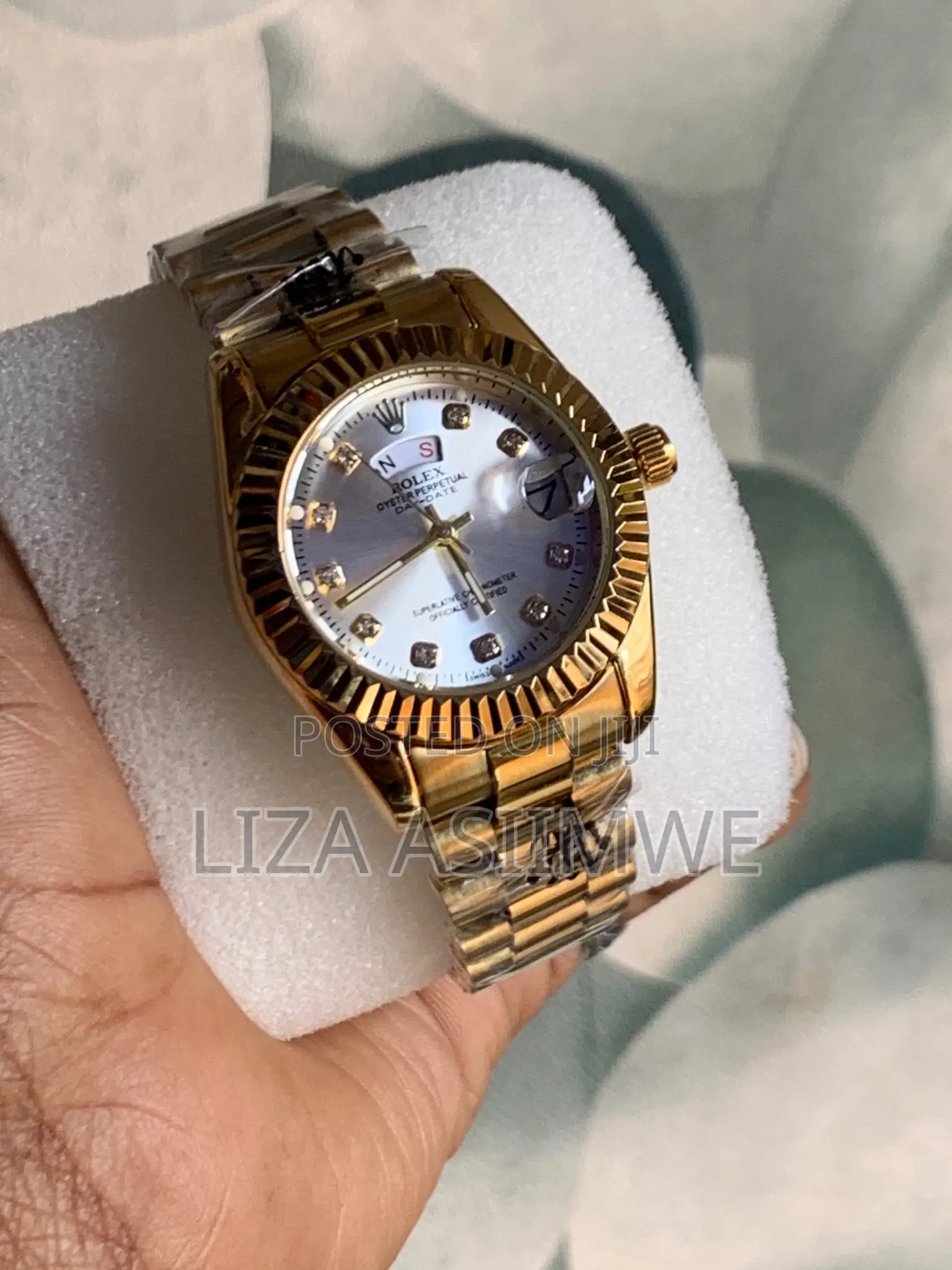 Lady’S Gold Rolex Watch With a White Dial
