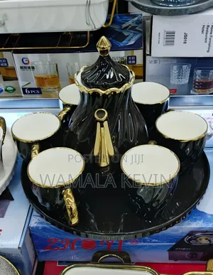 Aback and Gold Colour Scheme With Teapot and Aserving Tray