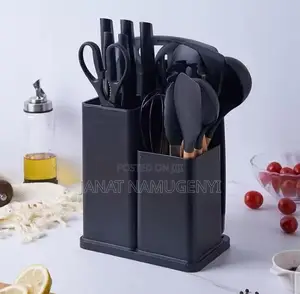 A Set of Black Cooking Spoons, Knives and Chopping Board
