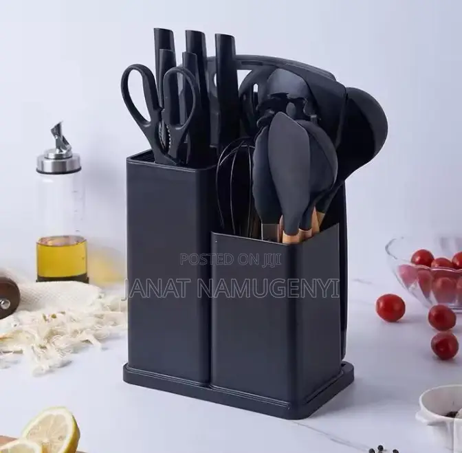 A Set of Black Cooking Spoons, Knives and Chopping Board