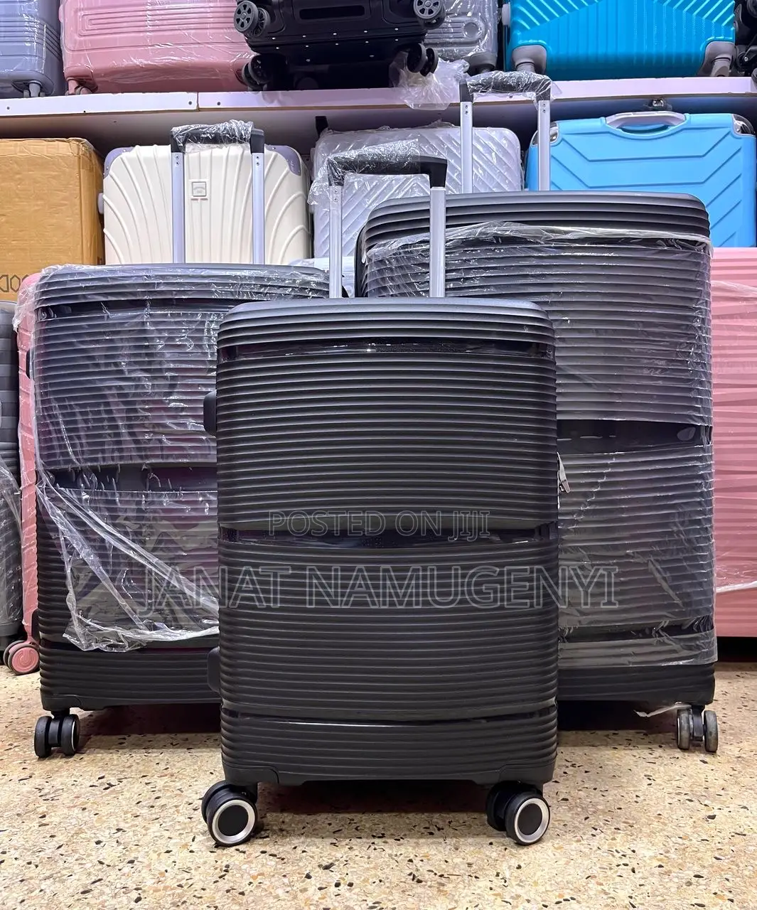 A Set of Lined Black Rubber Suitcases