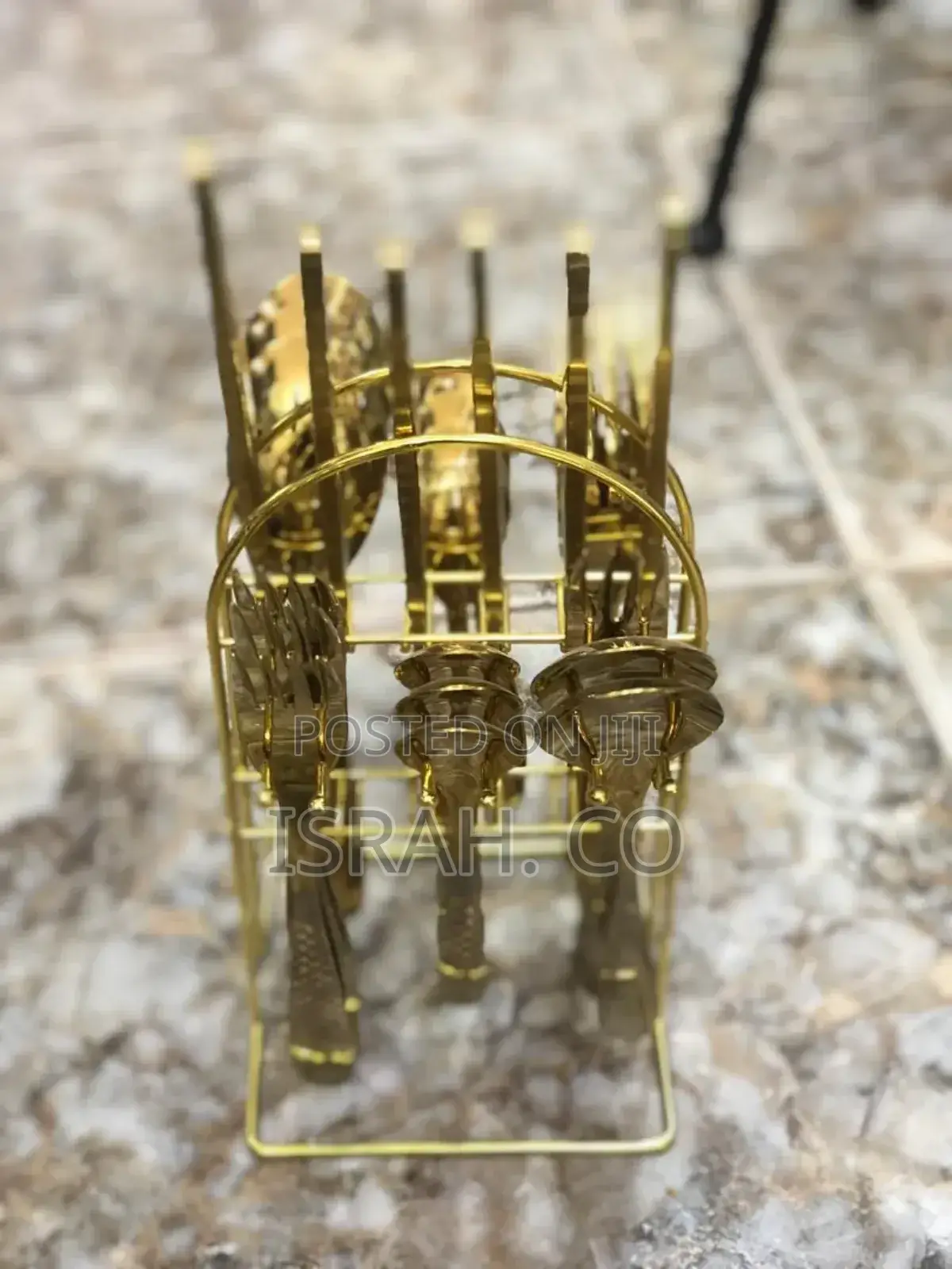 A 24-Piece Gold Cutlery Set With a Stand