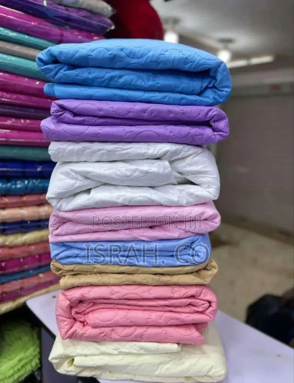 Stack of Folded Mattress Protectors in Various Colors