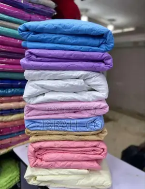 Stack of Folded Mattress Protectors in Various Colors