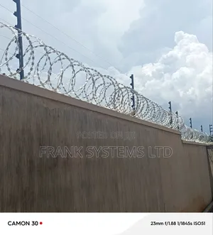 Electric Fence System With Razorwire on Residential House