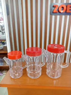 Three Transparent Acrylic Oil Dispenser Bottles With Red Lid