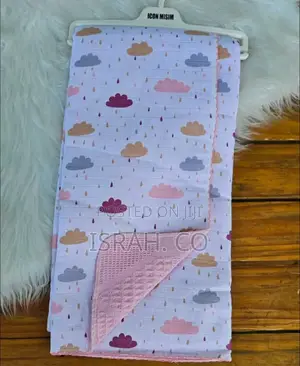 Baby Blanket With a Cloud and Raindrop Pattern.