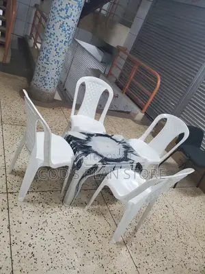 White Armless Plastic Chairs and Multicolored Plastic Table