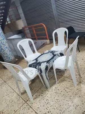 White Armless Plastic Chairs and Multicolored Plastic Table