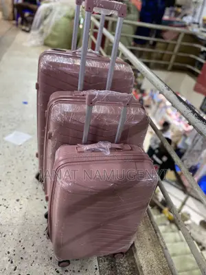 A Set of 3 Rubber Pink Suitcases