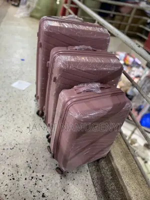 A Set of 3 Rubber Pink Suitcases