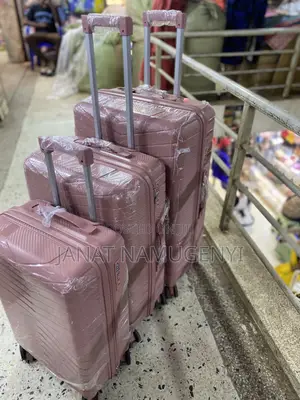 A Set of 3 Rubber Pink Suitcases