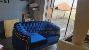 Well Buttoned 2 Seater Sofa With Golden Designs and Legs
