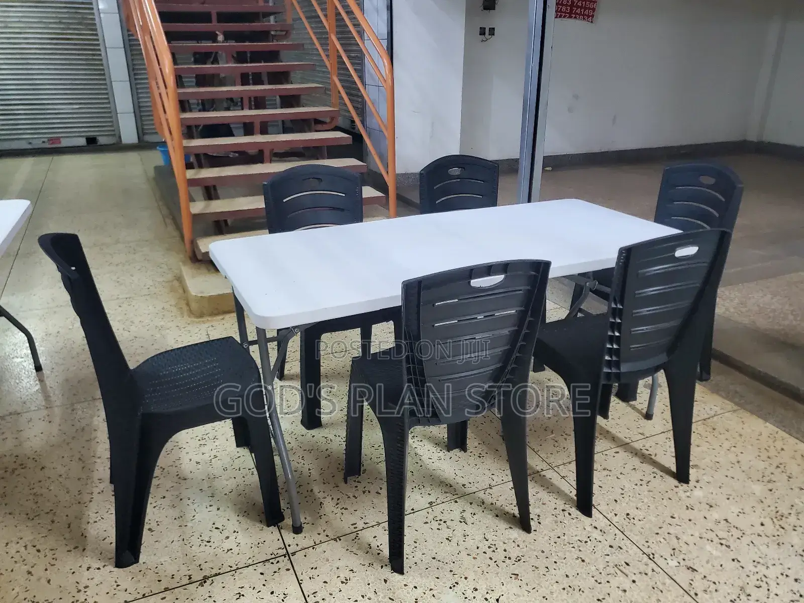 6 Imported Plastic Chairs and Rectangular Plastic Table