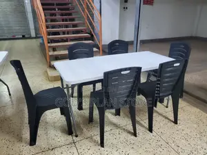 6 Imported Plastic Chairs and Rectangular Plastic Table